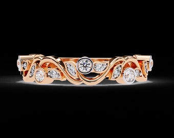 May include: Rose gold band ring with a flowing, leaf-like design. The ring features multiple round, clear diamonds set within the swirling metalwork. The ring's design is symmetrical and elegant, with a polished finish.
