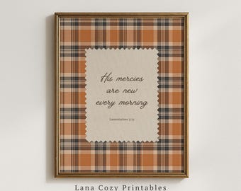 May include: A framed wall art print featuring a brown, tan, and black plaid pattern background. Centered is a beige rectangular paper with pinked edges containing the black text: His mercies are new every morning Lamentations 3:23.