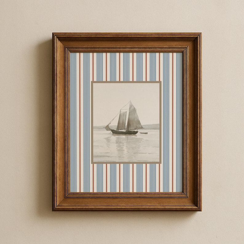 May include: A framed nautical print featuring a sepia-toned sailboat on the water. The frame is a warm brown, and the background has vertical stripes in blue, red, and cream. The artwork is a square format.
