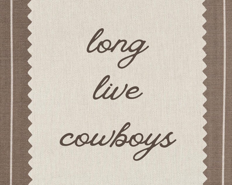 May include: A beige fabric with brown vertical stripes and a decorative edge. The words "long live cowboys" are written in a cursive font in the center of the fabric.