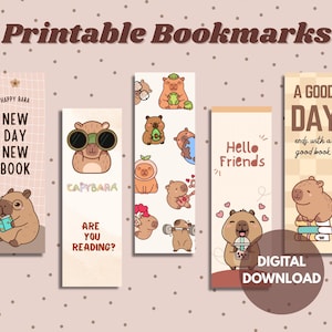 May include: Set of five printable bookmarks featuring cartoon capybaras in various poses. Each bookmark has a unique design with phrases like "New Day New Book" and "A Good Day ends with a good book". The words "Digital Download" are also visible.