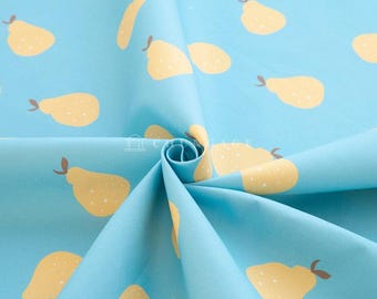 May include: A blue fabric with a repeating pattern of yellow pears. The fabric is folded in the center, showing the pattern on both sides.