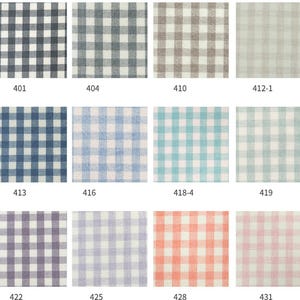 May include: A collection of fabric swatches with various gingham patterns. The swatches display a range of colors, including black, gray, blue, and pastel shades of pink, orange, and green. Each swatch is labeled with a number.