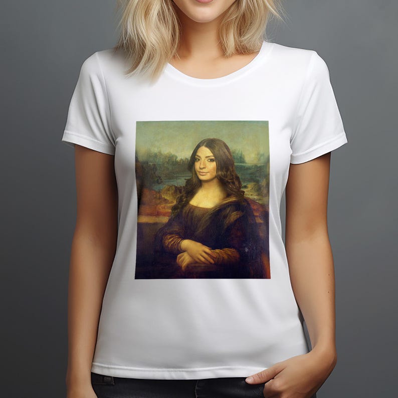 May include: A white t-shirt with a printed image of a woman in a painting, similar to the Mona Lisa, with a neutral expression and long brown hair.