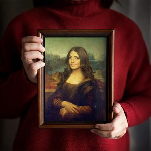 May include: A framed portrait of a woman with long brown hair, wearing a dark blue dress, in the style of the Mona Lisa.