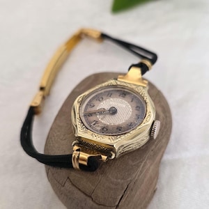 rolex de oro con correa de cuero