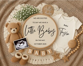 May include: A white onesie with the text "Baby Taylor" on it, a brown teddy bear, a wooden sign with the text "We are excited to say we have a Little Baby on the way! October 2025", a wooden bead garland, and a wooden block spelling out "BABY".