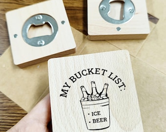 May include: Three wooden bottle openers and a coaster. Two bottle openers are square with a metal opener attached. The coaster has the text "MY BUCKET LIST: ICE BEER" and a graphic of beer bottles in a bucket.