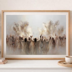 May include: A framed art print featuring a blurred image of figures with raised arms, in neutral tones. The artwork has a soft, ethereal quality, with light and shadow creating depth. The print is in a wooden frame.