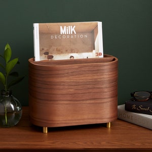 May include: A walnut wood magazine holder with brass feet. The holder is filled with a copy of Milk Decoration magazine, issue 30.