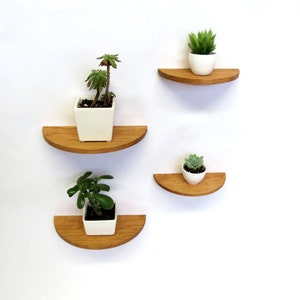 Set of four half round cherry wood floating shelves