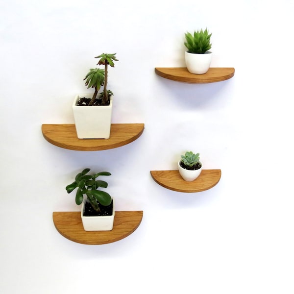 Set of four half round cherry wood floating shelves