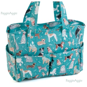 May include: Teal blue canvas tote bag with multiple pockets. The bag features a repeating pattern of dogs in various breeds and poses, with white bones scattered throughout.