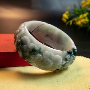 61MM Premium Natural Burmese Jadeite Jade Bracelet White with Dark Green Highlights Hand-Carved Pikul Flower Symbol Elegance and Good Luck
