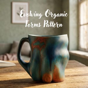 May include: A ceramic mug with an irregular, wavy silhouette and a handle. The surface features a blended glaze of deep teal, blue, and burnt orange tones. The text "Evolving Organic Forms Pattern" is displayed in white script above the mug.