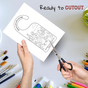 May include: A white door hanger with a black and white illustration of a biblical scene is being cut out with scissors. The text "Ready to CUTOUT" is above the door hanger. The door hanger has the text "Share truth with courage."