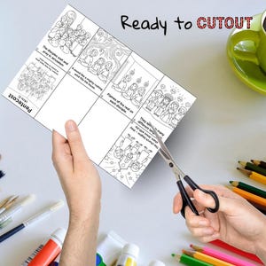 May include: A sheet of paper with black line drawings and text is being cut with scissors. The text says "Ready to CUTOUT" and describes scenes from Pentecost. Colour pencils, paint tubes, and a green mug are in the background.