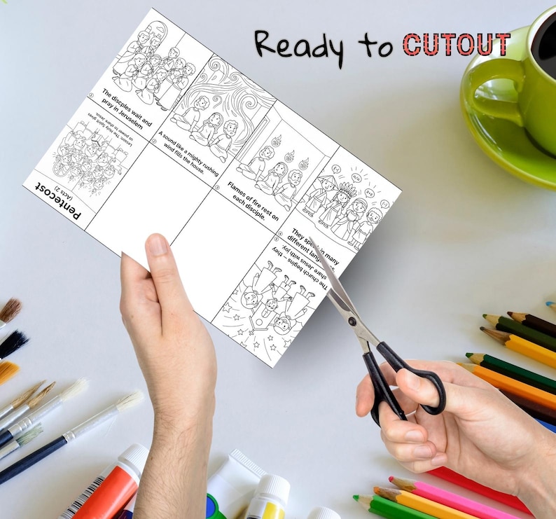 May include: A sheet of paper with black line drawings and text is being cut with scissors. The text says "Ready to CUTOUT" and describes scenes from Pentecost. Colour pencils, paint tubes, and a green mug are in the background.