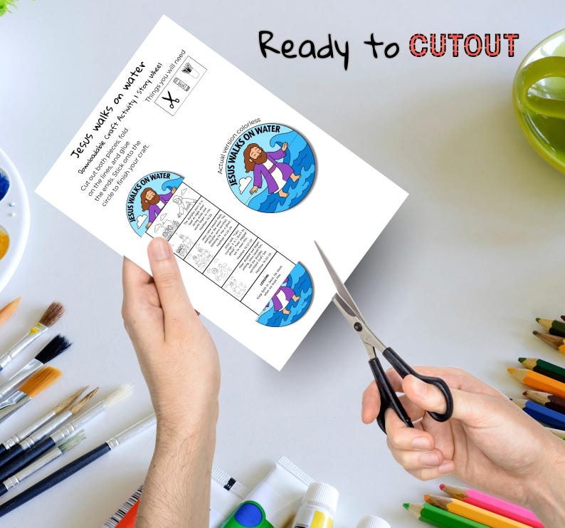 May include: A white paper craft activity sheet titled "Jesus walks on water" with a colorful illustration of Jesus walking on water. The sheet includes instructions and is being cut with scissors. The text "Ready to CUTOUT" is at the top.