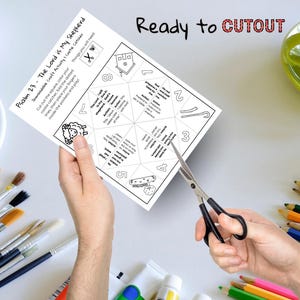 May include: A black and white printable craft activity sheet titled "Psalm 23 - The Lord is My Shepherd." The sheet includes instructions, illustrations, and the text "Ready to CUTOUT." Scissors are cutting the sheet.