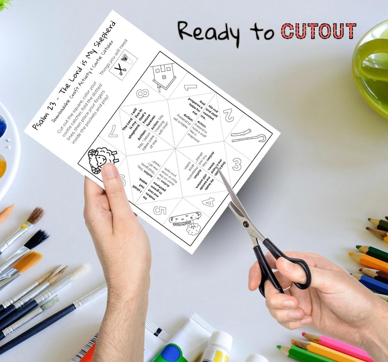 May include: A black and white printable craft activity sheet titled "Psalm 23 - The Lord is My Shepherd." The sheet includes instructions, illustrations, and the text "Ready to CUTOUT." Scissors are cutting the sheet.