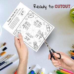 May include: A white paper craft activity titled "Prayer Model (ACTS)" is being cut with scissors. The paper has instructions and a cootie catcher design. The words "Ready to CUTOUT" are written at the top.