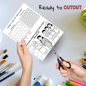 May include: A black and white coloring page featuring the text "Joseph's Coat of Many Colors" and a word search puzzle. The page also includes illustrations of biblical figures and the text "Ready to CUTOUT". Scissors are cutting the page.