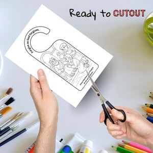 May include: A white door hanger with a black and white illustration of a biblical scene. The text "Forgive as God forgives" is printed on the top, and "Jesus teaches us to forgive as we are forgiven" is printed on the bottom. The words "Ready to CUTOUT" are printed in black and red.