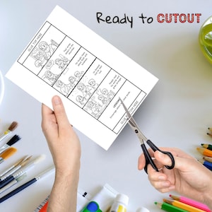 K&ouml;nnte beinhalten: Ein wei&szlig;es Papier mit einer Schwarz-Wei&szlig;-Comic-Strip-Illustration wird mit einer Schere geschnitten. Der Text "Ready to CUTOUT" steht oben. Der Comic-Strip zeigt eine Geschichte mit Textblasen und den Worten "GLUE TOP HERE" und "GLUE BOTTOM HERE".