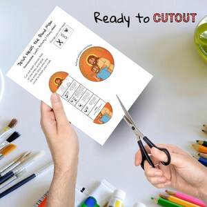 May include: A sheet of paper with the title "Jesus Heals the Blind Man" and illustrations, being cut with scissors. The text "Ready to CUTOUT" is visible at the top of the page.