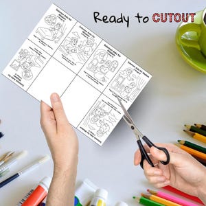 May include: A sheet of black and white illustrations titled "Solomon Asks for Wisdom" is being cut with scissors. The sheet has multiple panels with drawings and text. The words "Ready to CUTOUT" are written in black and red.