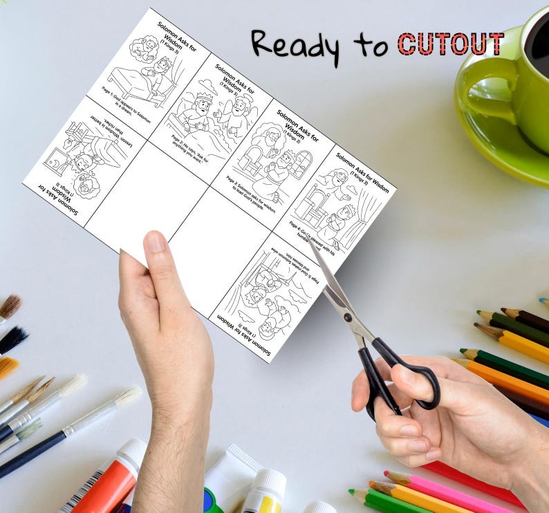 May include: A sheet of black and white illustrations titled "Solomon Asks for Wisdom" is being cut with scissors. The sheet has multiple panels with drawings and text. The words "Ready to CUTOUT" are written in black and red.