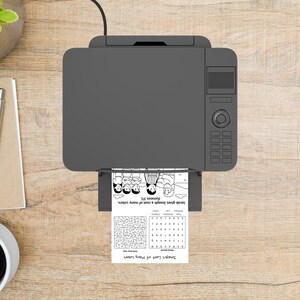 May include: A grey printer printing a black and white page with the text "Joseph's Coat of Many Colors" and an illustration of people. The page also includes a maze and the text "Jacob gives Joseph a coat of many colours (Genesis 37)."