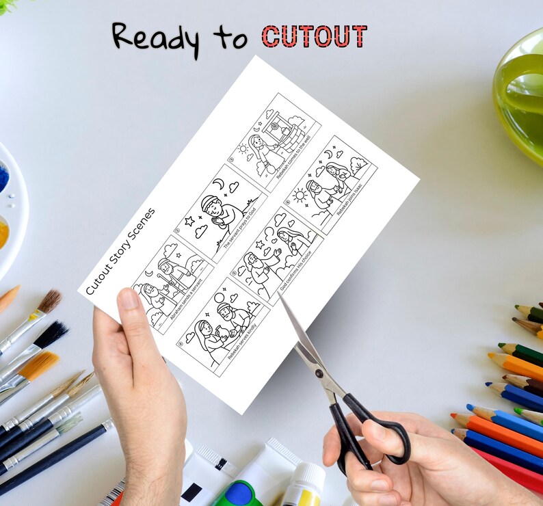 Puede incluir: Una hoja de papel blanca con ilustraciones en blanco y negro de escenas b&iacute;blicas se corta con tijeras. El texto "Ready to CUTOUT" y "Cutout Story Scenes" es visible. Pinceles, pintura y l&aacute;pices de colores est&aacute;n en el fondo.