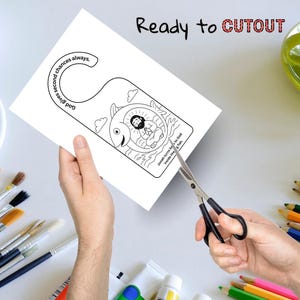 May include: A white paper door hanger with a black and white illustration of Jonah inside a fish. The text "God gives second chances always" and "Jonah turns back to God inside the fish" are included. The words "Ready to CUTOUT" are at the top.