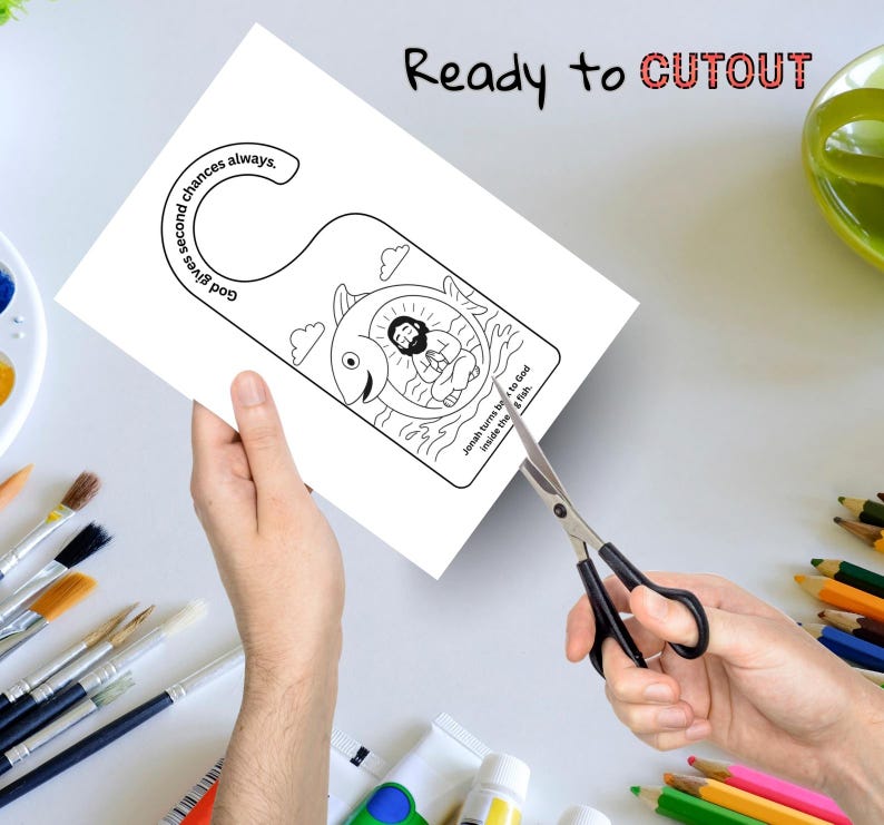 May include: A white paper door hanger with a black and white illustration of Jonah inside a fish. The text "God gives second chances always" and "Jonah turns back to God inside the fish" are included. The words "Ready to CUTOUT" are at the top.