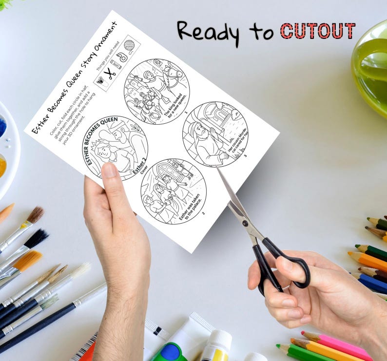 May include: A black and white paper craft featuring the story of Esther, with the text "Esther Becomes Queen Story Ornament" and "Ready to CUTOUT". The paper is being cut with scissors.