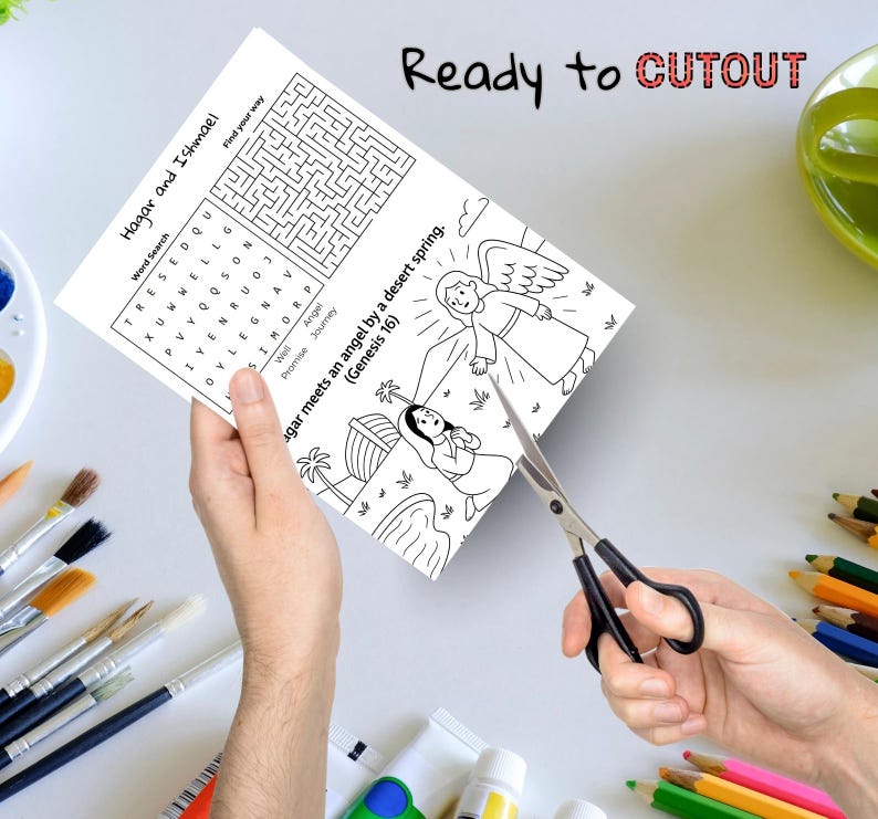 May include: A black and white activity sheet with a word search and illustration is being cut out with scissors. The text on the sheet reads "Hagar and Ishmael" and "Ready to CUTOUT". The illustration depicts an angel and a woman.