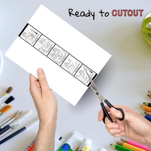 May include: A white paper with a black and white illustrated strip is being cut with scissors. The strip contains six sequential images. The text "Ready to CUTOUT" is written in black and red above the paper.