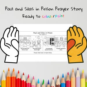 May include: A coloring book page titled "Paul and Silas in Prison Prayer Story." The black and white illustrations depict scenes from the story, with text that reads "Ready to colour/Paint." A collection of colored pencils is at the bottom.