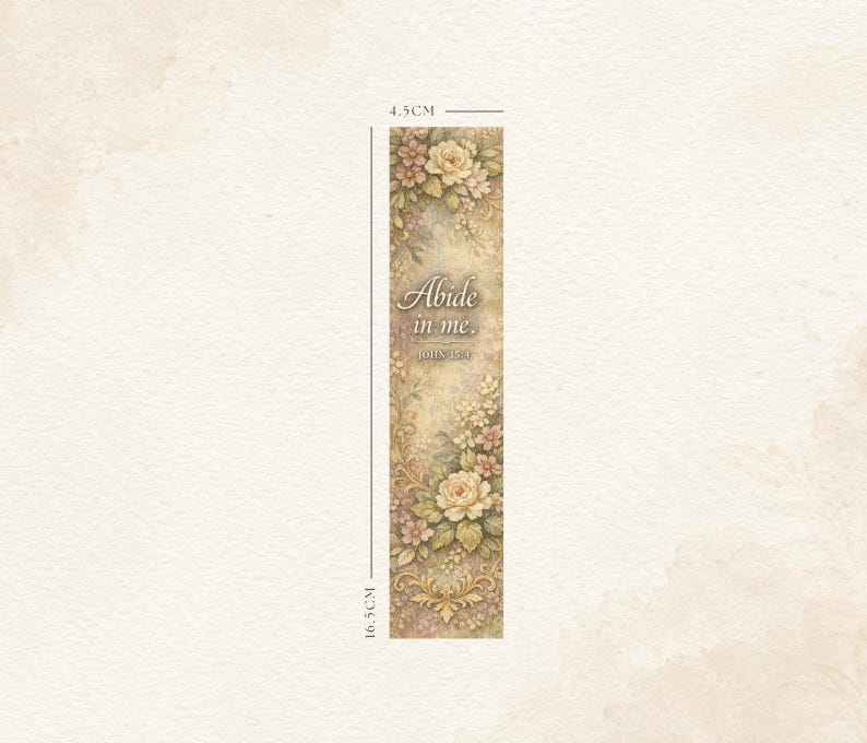 May include: A floral bookmark, 16.5 cm long and 4.5 cm wide, featuring a cream-colored background with a vintage design. The bookmark is adorned with roses and other flowers in shades of cream, pink, and green. The text "Abide in me. John 15:4" is printed on the bookmark.