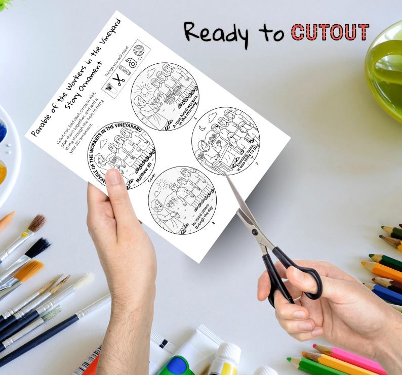 May include: A white paper with a black and white illustration of the Parable of the Workers in the Vineyard story ornament. The text "Ready to CUTOUT" is at the top. Scissors are cutting the paper.