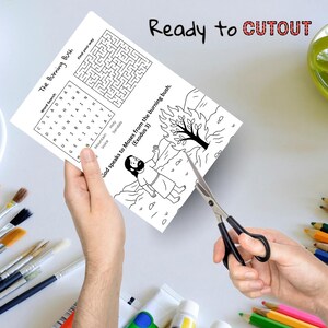 May include: A black and white activity sheet with the text "The Burning Bush" and "Ready to CUTOUT". The sheet includes a word search, a maze, and an illustration of Moses. Scissors are cutting the sheet.