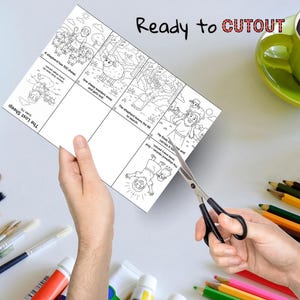 May include: A black and white illustrated cutout sheet with the text "Ready to CUTOUT". The sheet depicts a story about a shepherd and a lost sheep. Scissors are cutting the sheet. Colored pencils, paint tubes, and a green mug are in the background.