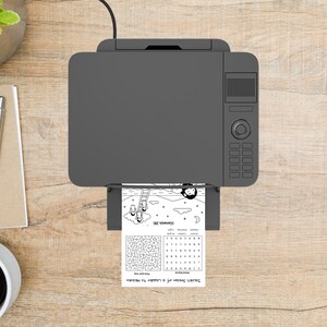 May include: A gray printer is printing a black and white coloring page with the text "Jacob's Dream of a Ladder to Heaven". The page includes a maze, a word search, and illustrations of angels.
