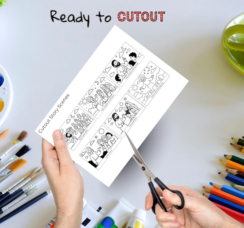 May include: A white sheet of paper with black and white illustrations of biblical scenes is being cut with scissors. The text "Ready to CUTOUT" and "Cutout Story Scenes" are visible. Paintbrushes, colored pencils, and a paint palette are in the background.