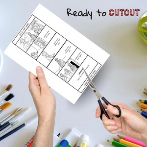 Puede incluir: Un papel blanco con una tira c&oacute;mica en blanco y negro est&aacute; siendo cortado con tijeras. El texto "Ready to CUTOUT" est&aacute; escrito en negro y rojo. Pinceles y l&aacute;pices de colores est&aacute;n en el fondo.