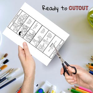 May include: A white paper with a black and white illustrated story, being cut with scissors. The paper has text that reads "Ready to CUTOUT" and "GLUE TOP HERE" and "GLUE BOTTOM HERE".