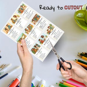 May include: A sheet of illustrated cards with religious themes is being cut with scissors. The cards feature colorful drawings and text. The words "Ready to CUTOUT" are written in red and black. A green mug and colored pencils are in the background.