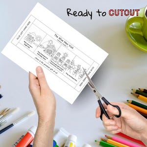 May include: A black and white coloring page titled "The Wise Men Visit" with text that reads "Ready to CUTOUT". The page is being cut with scissors. A green mug and art supplies are in the background.